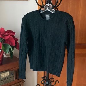 Black cashmere sweater. Cable design, with ribbed waist and wrists.